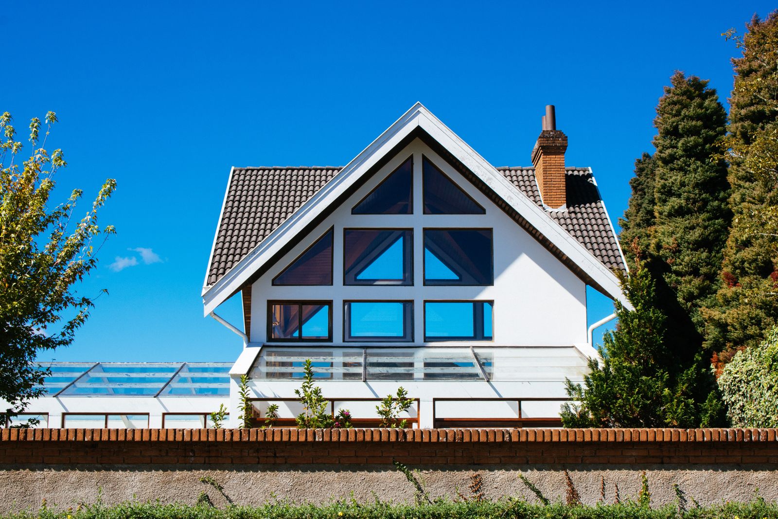 An A-frame house with a full-height glazed gable.